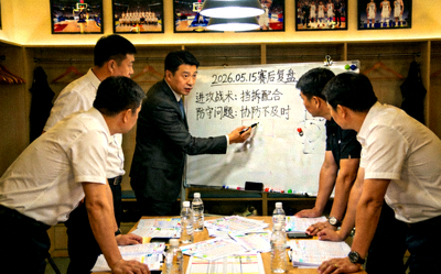 2026年篮球赛后复盘分析，教练团队在战术板前讨论比赛细节